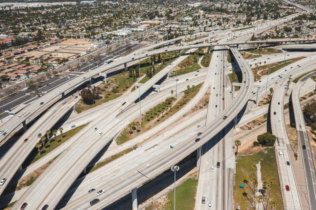 pexels-photo-8783845-8783845 A high-angle aerial shot of a sprawling urban highway interchange with light traffic.